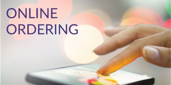 Hand holding a digital tablet ordering materials online