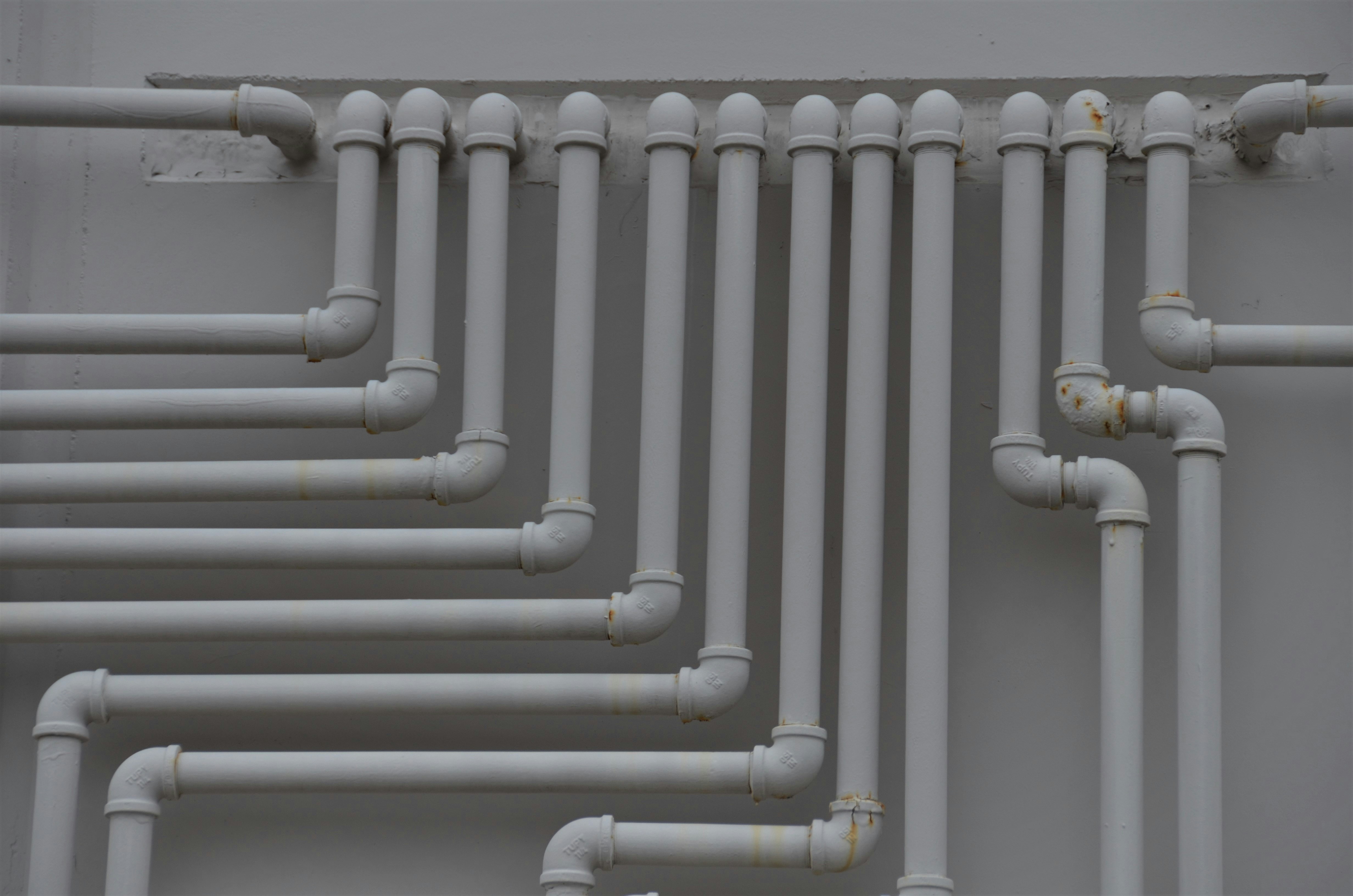 a stack of white PVC piping